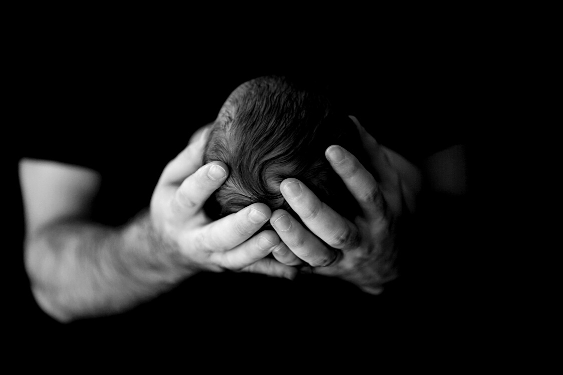 Newborn in Dad's Hands