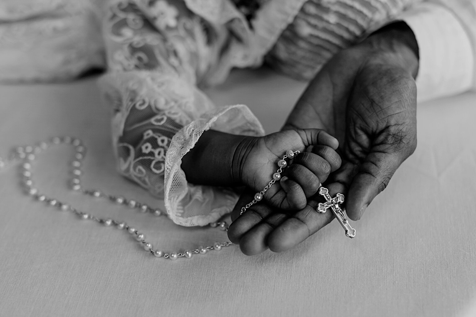 Baby Holding a Rosary